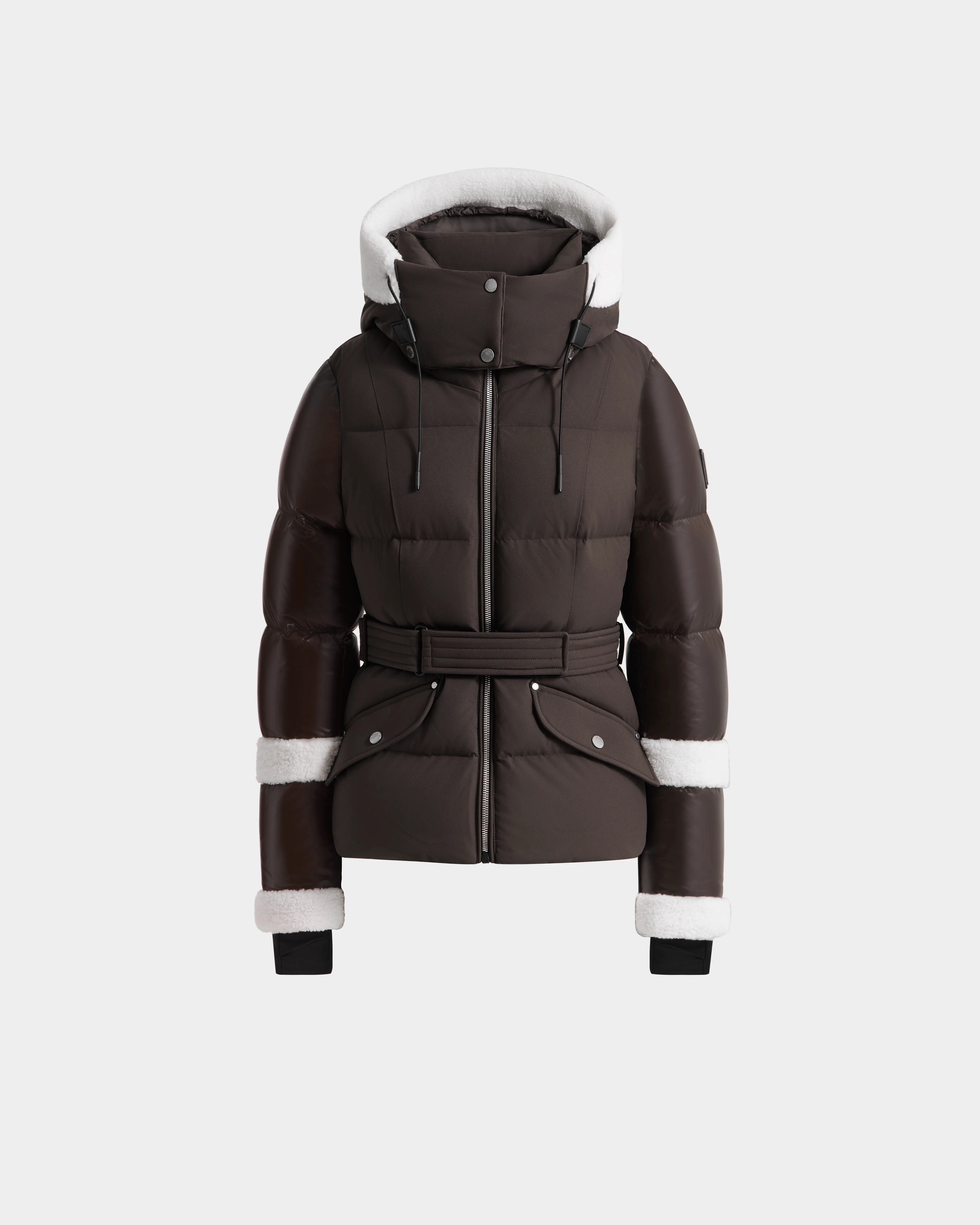 The Rudsak AUDREY - 8124582 Espresso is a dark brown down puffer jacket with a belted waist, white faux fur trim, front zipper closure, two snap pockets, and black ribbed wrist cuffs—crafted from recycled Stormshell fabric.