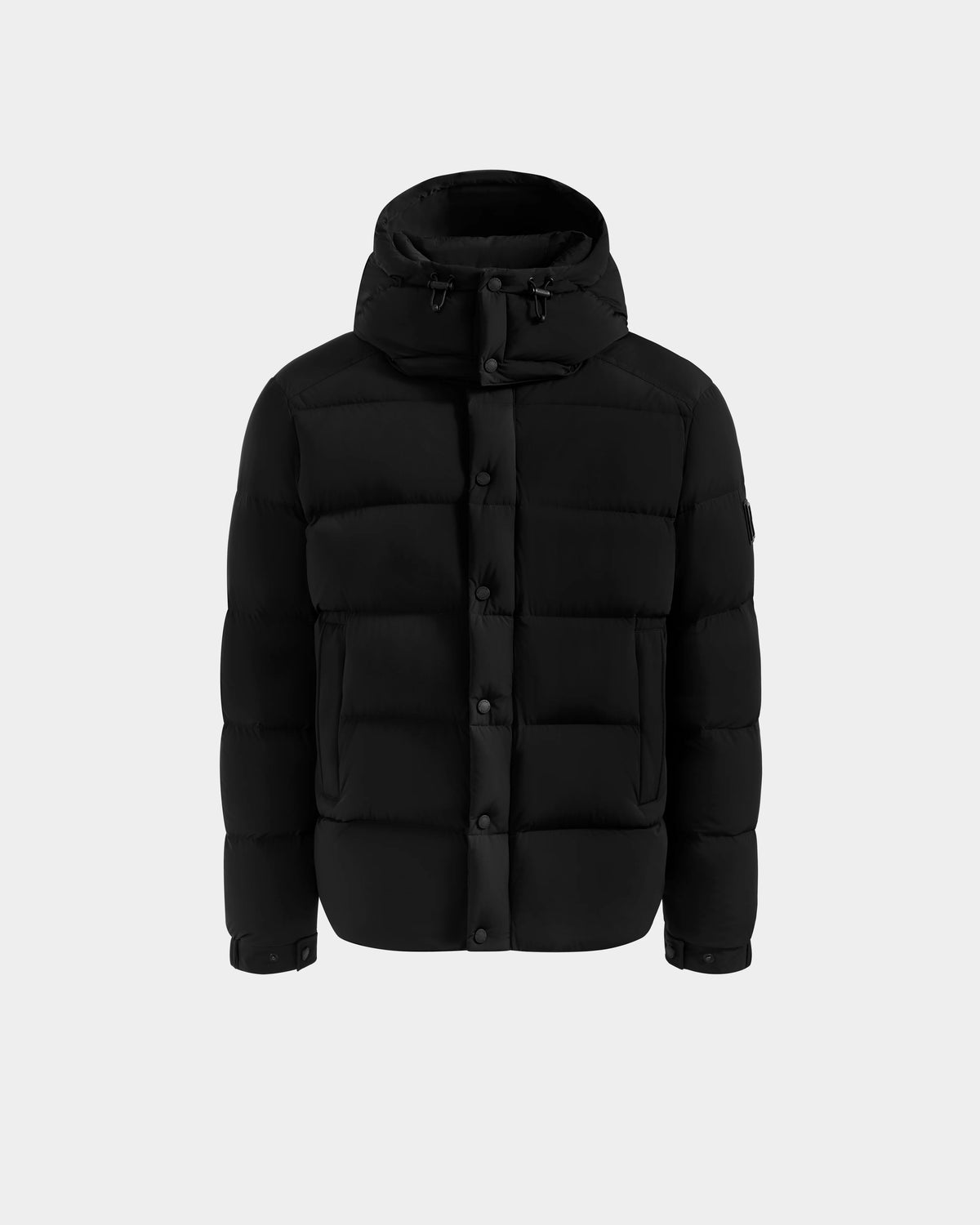 The Rudsak BRAYDEN M-S - M125524 Black is a men’s down puffer jacket with a hood, front button closure, and two large front pockets, crafted with RDS-certified down, shown on a plain light gray background.