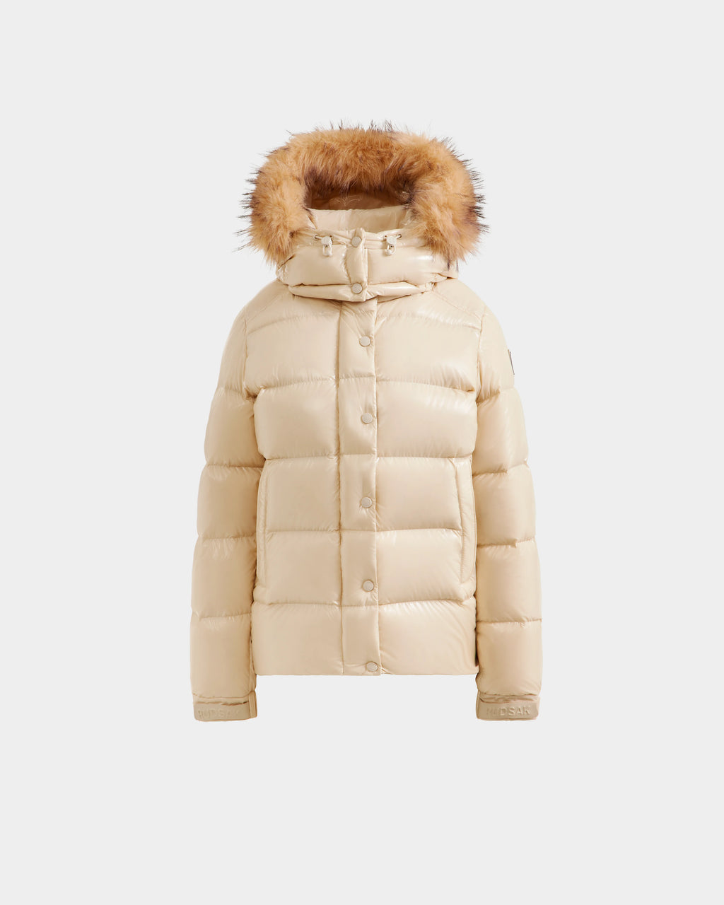 The Rudsak BREE S - L125583 Vanilla is a beige women’s down puffer jacket with a fur-lined removable hood, front snap buttons, and horizontal quilting, shown against a plain white background.