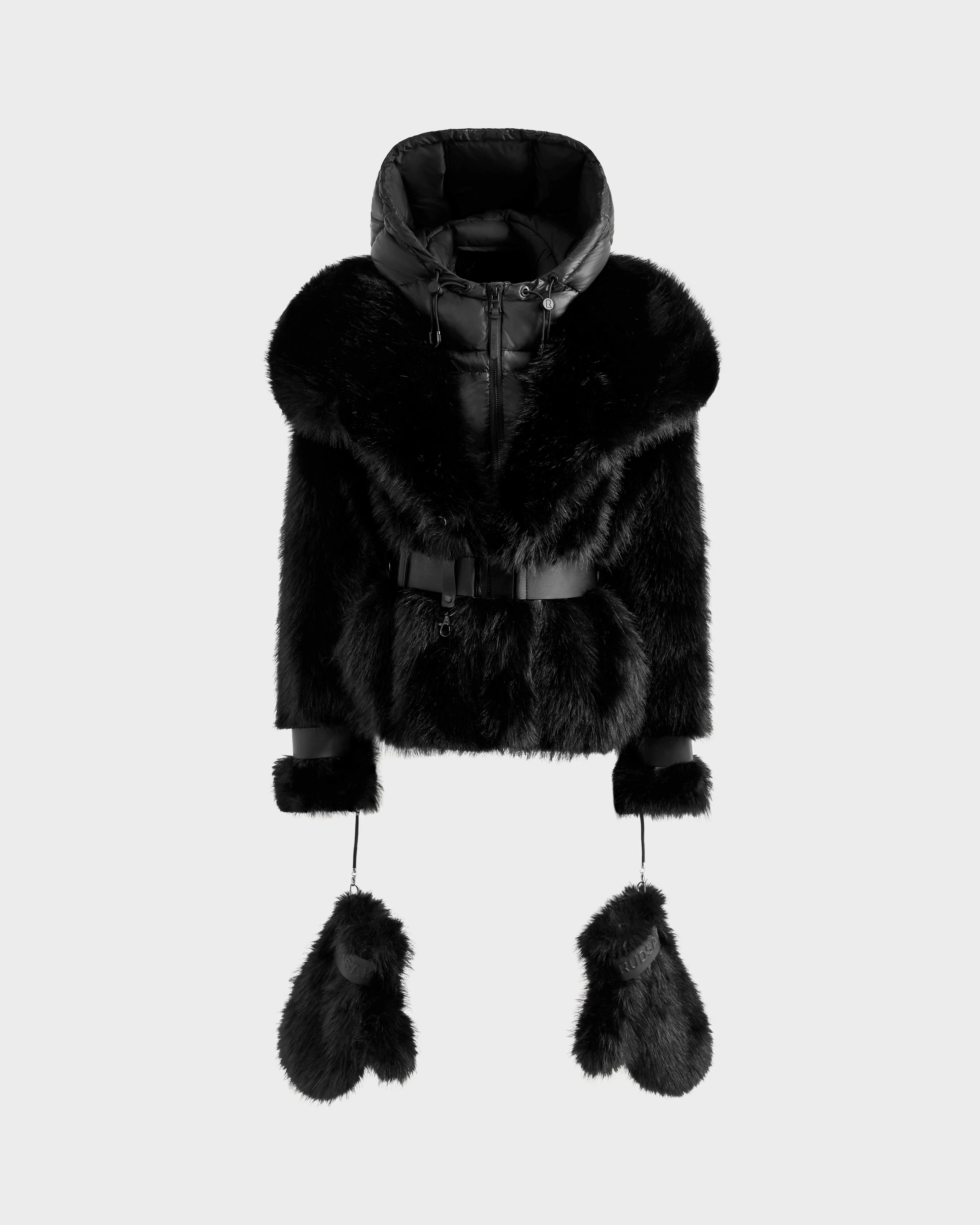 The CHLOE - 8125619 Black by Rudsak is a women's black faux fur jacket with a hood, belted waist, and matching fur mittens attached by cords—an elegant winter staple, shown on a plain light background.