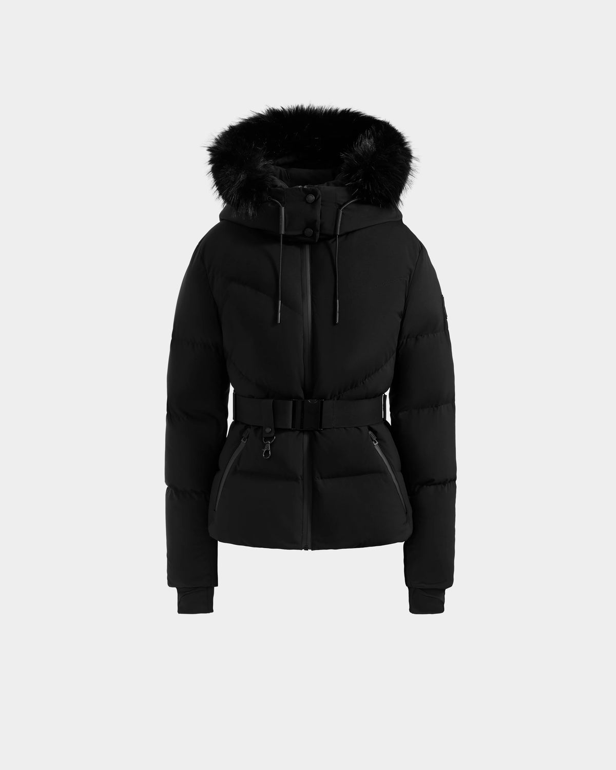 The Rudsak CHRISTELLE M - L125542 Black is a belted, quilted down puffer jacket with a faux fur-trimmed hood, front zipper, snap buttons, and two front pockets, shown on a plain light gray background.