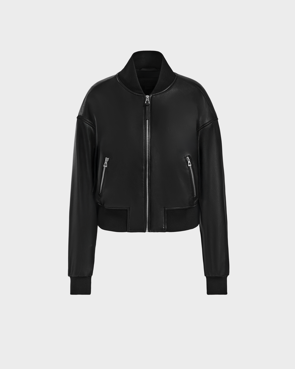 The EMERSON - 8125041 Black by Rudsak is a modern black leather bomber jacket with a cropped fit, front zipper, ribbed collar, cuffs and hem, and two zippered side pockets—shown on a plain light gray background.