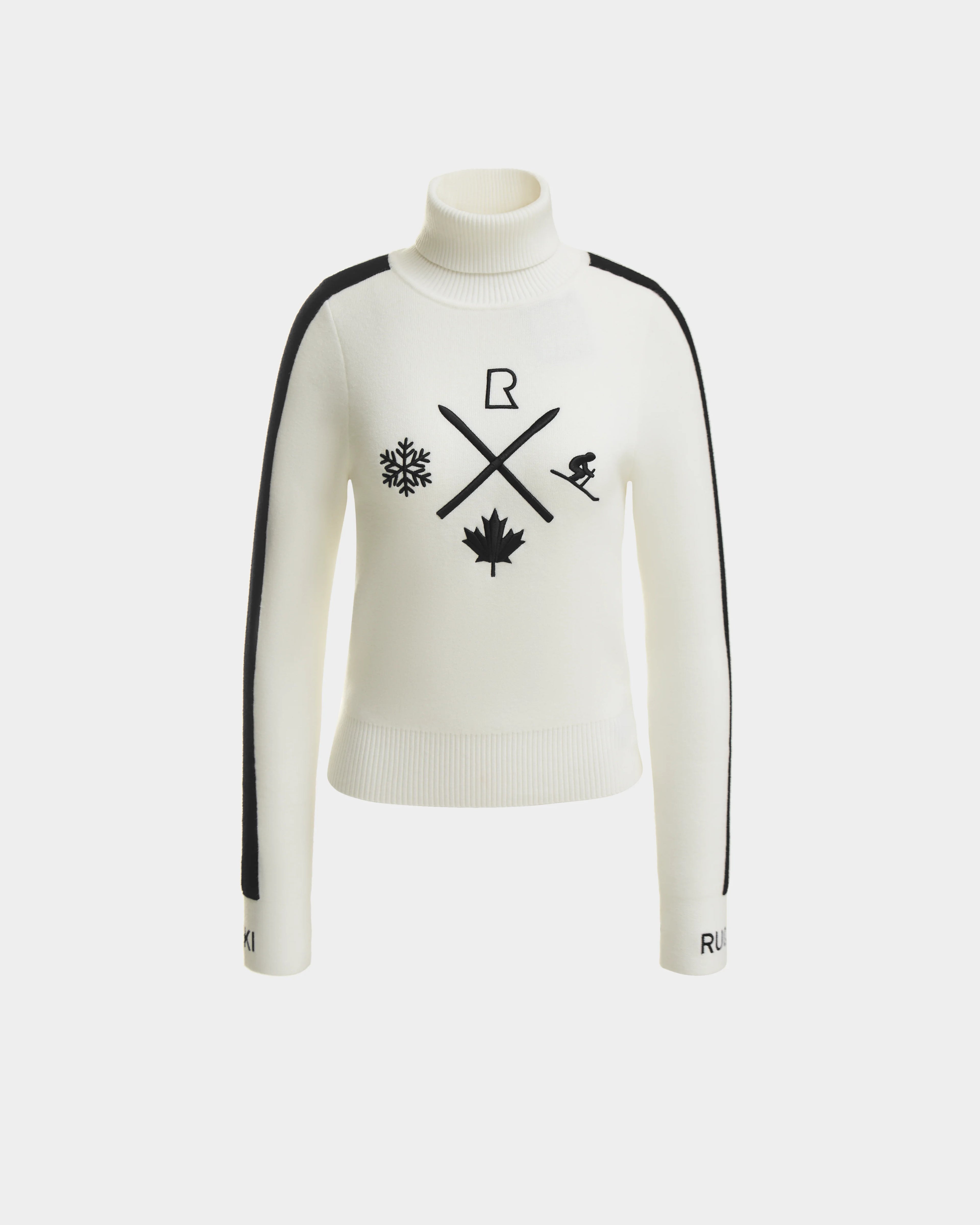 The ELIZABETH - 8524623 Optic White by Rudsak is a women’s ski turtleneck with black shoulder stripes and winter graphics—snowflake, crossed ski poles, maple leaf, and skier. RUKI accents the cuffs for an après-ski flair.