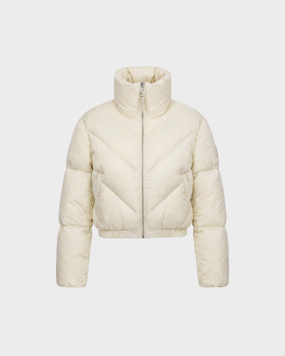 The ANSLIE - 8126986 Vanilla by Rudsak is a cream-colored women’s cropped puffer jacket, featuring a high collar, front zipper, and long sleeves. Crafted with RDS-certified down, this stylish piece is showcased against a plain white background.