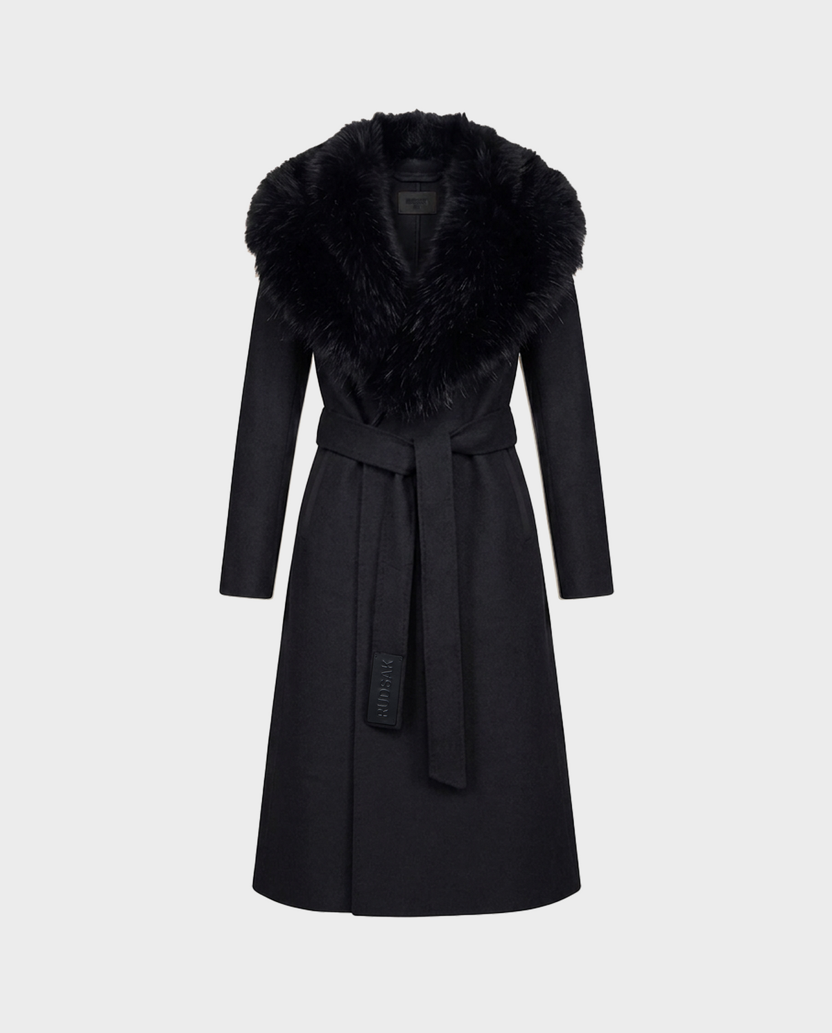 The CINDY - 8126526 Black coat by Rudsak is a long, black belted wool coat featuring a luxurious faux fur collar, shown against a plain light grey background. Expertly crafted from a soft cashmere blend, this coat offers a tailored fit and boasts a smooth, elegant finish.