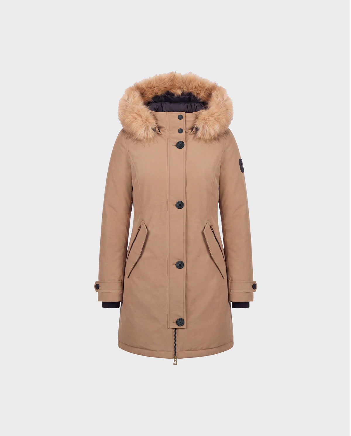 The Rudsak KEYSHIA - 8126517 Camel women’s down parka features a faux fur-lined hood, black buttons, front zipper, two front pockets, and a patch on the left sleeve. Crafted with ethically sourced RDS-certified down for cozy winter warmth, this stylish tan parka is displayed against a plain light gray background.