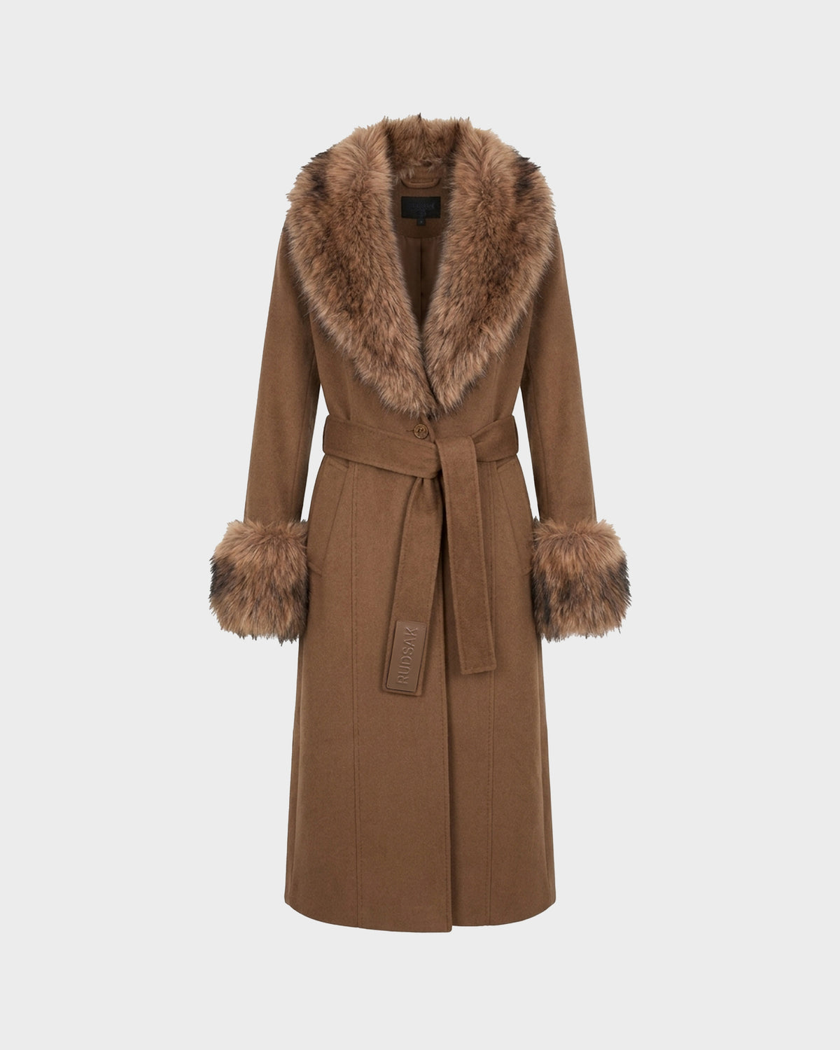 The Rudsak MARILLA WL - 8126737 Dark Caramel is a long brown wool coat with a wide faux fur collar and fur cuffs, finished with a matching fabric belt at the waist. Displayed against a plain light background, this tailored outerwear piece combines classic elegance and cozy details for timeless appeal.