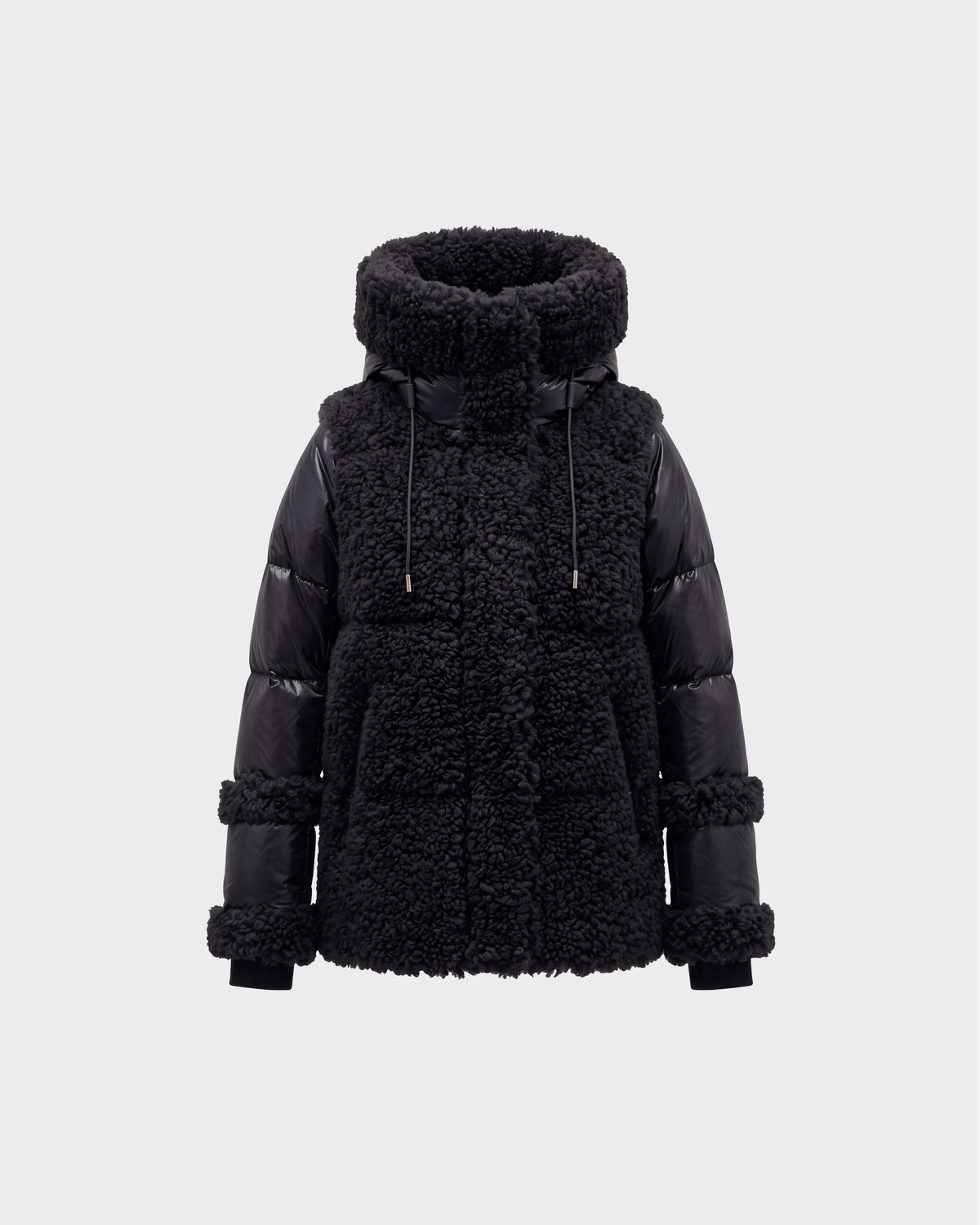 The MARISSA - 8126728 Black by Rudsak is a stylish winter jacket featuring a high, padded collar, shearling-textured body, and smooth quilted sleeves. This sherpa coat includes drawstrings at the collar and boasts chunky, textured details on both the body and sleeves—making it an ideal piece of winter outerwear.