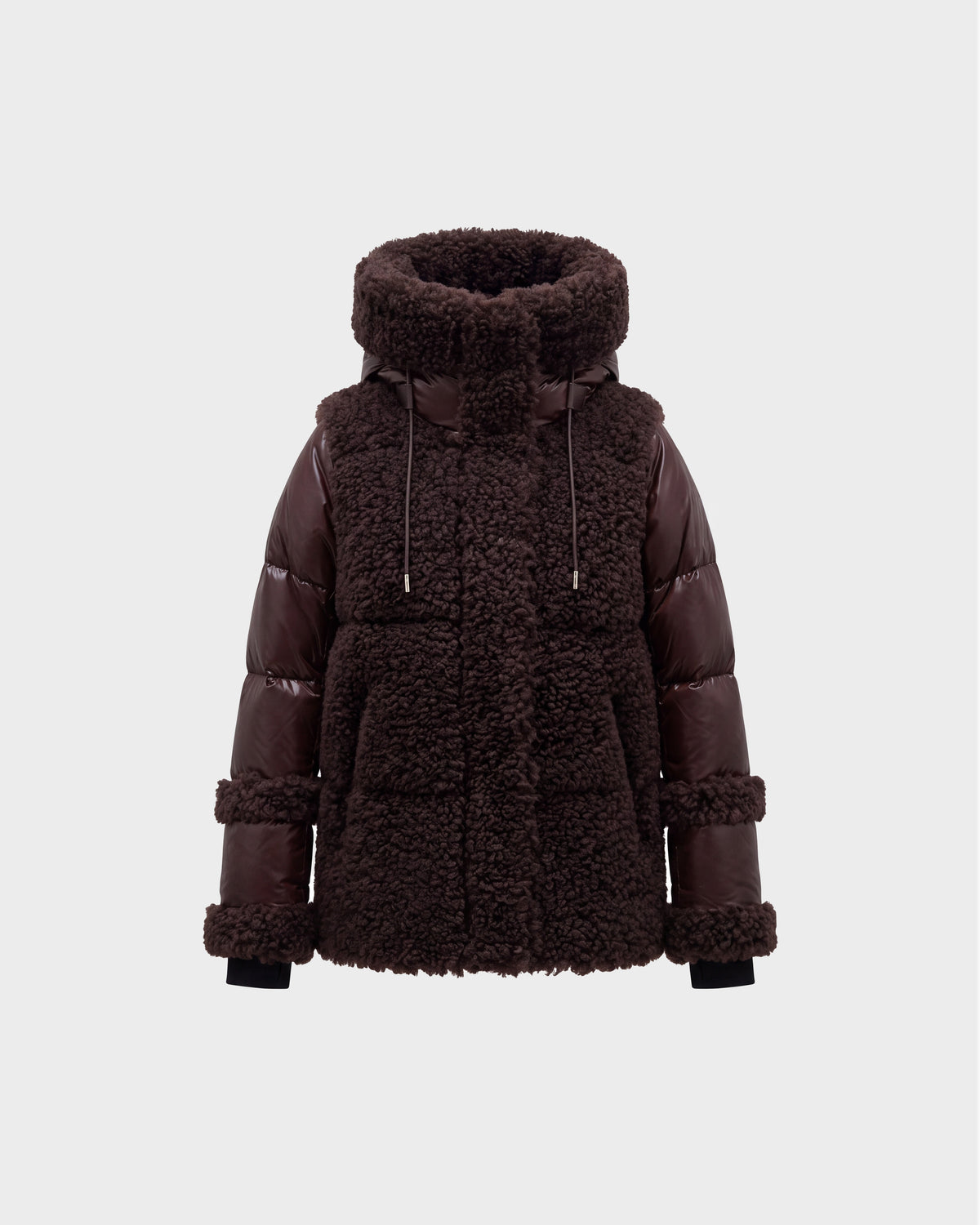 A women’s winter jacket, the MARISSA - 8126728 Espresso by Rudsak, in dark brown features a plush sherpa-textured body paired with smooth, quilted down sleeves. The design includes a high collar, drawstrings, and large front pockets. It is photographed against a plain light gray background.