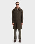 A man wearing sunglasses, a dark green wool blend overcoat with a brown fur collar, Rudsak’s NICO - 6126717 Olive trousers, and brown dress shoes stands facing forward against a plain white background—an ideal look for transitional layering.