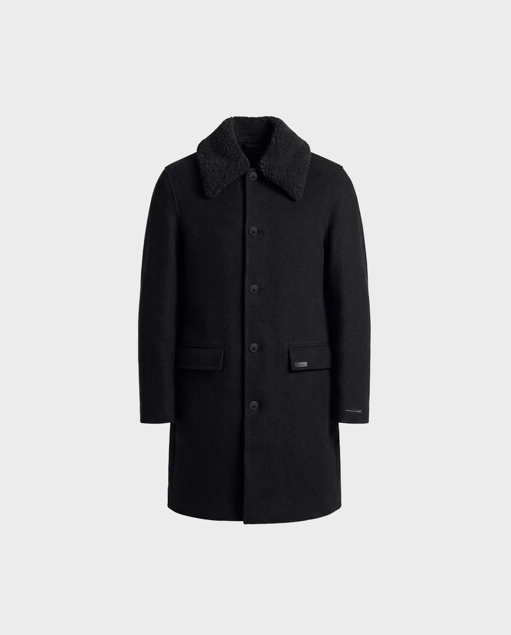 Experience timeless style with the NICO - 6126717 Black men’s long wool coat by Rudsak. This knee-length coat, crafted from a luxurious cashmere wool blend, features a textured, removable faux-shearling collar, a classic button-down front, and two front pockets. Shown here in black against a plain light gray background.