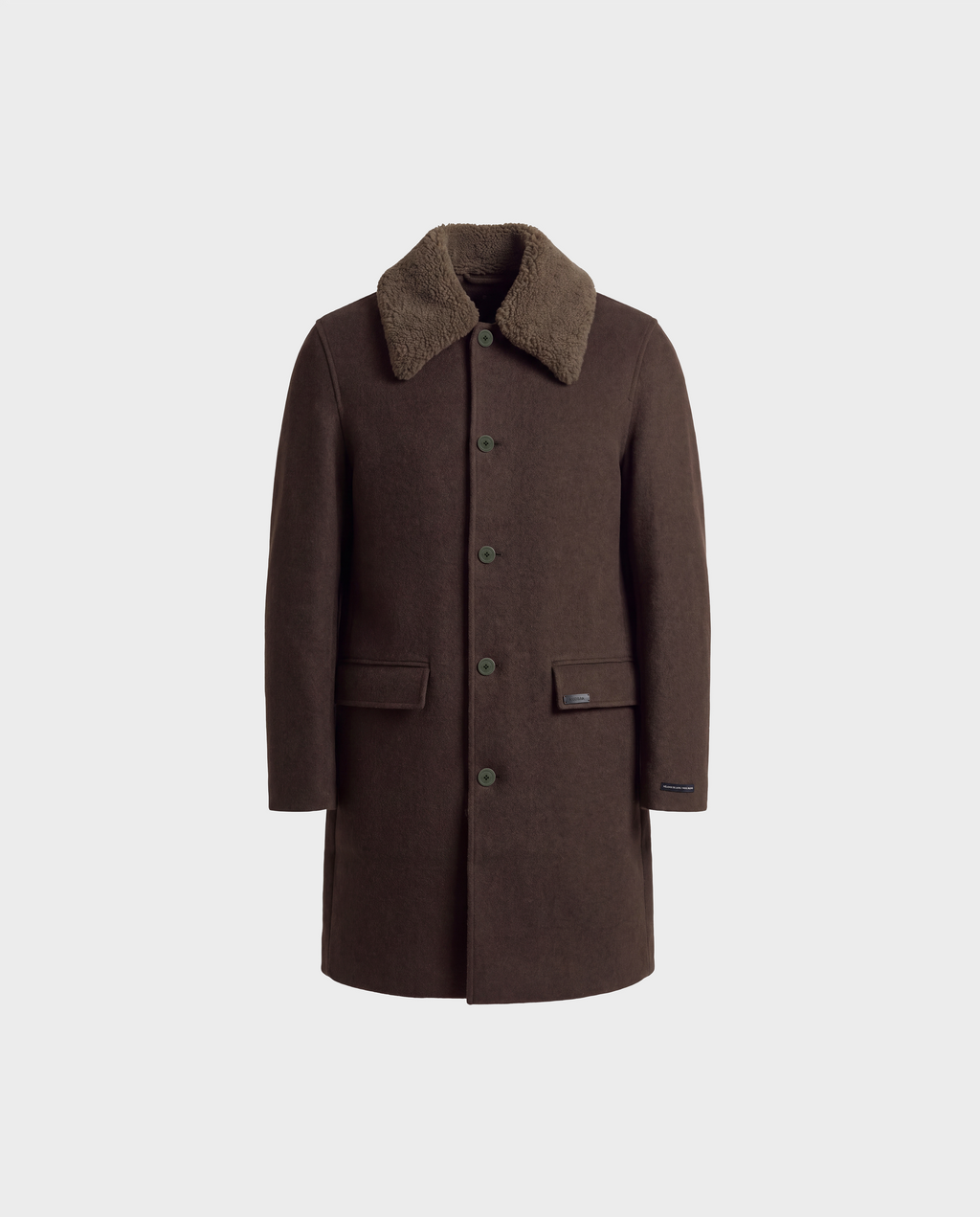 The Rudsak NICO - 6126717 Olive is a men’s long wool coat in dark brown, expertly crafted from a luxurious cashmere and yak blend. It features a textured, lighter brown removable faux-shearling collar, button closure, and two front flap pockets. The coat is displayed on a plain light gray background.
