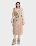 A woman stands facing forward, wearing the Rudsak NOELLE - 8126971 Cream plush faux fur coat with a belt, paired with matching ear muffs, boots, and a turtleneck. The outfit is cozy and winter-appropriate, featuring soft textures and neutral tones.