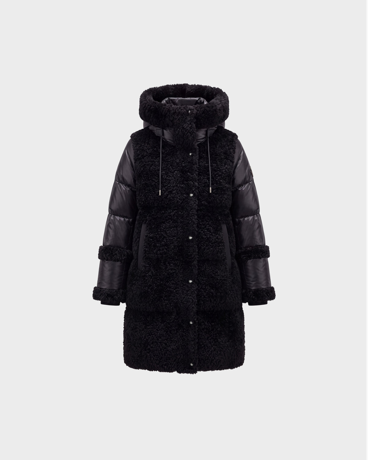The SHELLEY - 8126729 Black coat by Rudsak features a puffy, quilted design on the sleeves and sides, sherpa-textured panels on the body, a large hood, front buttons, and adjustable drawstrings. It is displayed against a plain light gray background.