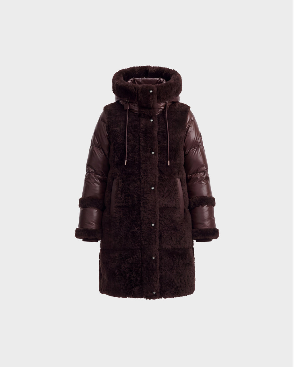 The SHELLEY - 8126729 Espresso by Rudsak is a sophisticated winter coat in dark brown, crafted with a blend of faux fur and puffer materials. It features sherpa-textured accents, a hood with drawstrings, long sleeves, snap buttons, and a straight silhouette—making it an elegant choice for winter outerwear.