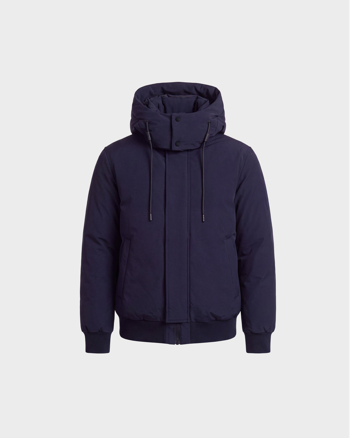 The Rudsak WILL - 6126561 Navy is a navy blue hooded winter coat inspired by the classic bomber jacket style, featuring RDS-certified down filling, a front zipper, snap buttons, drawstrings, and two side pockets. The coat is displayed on a plain white background.