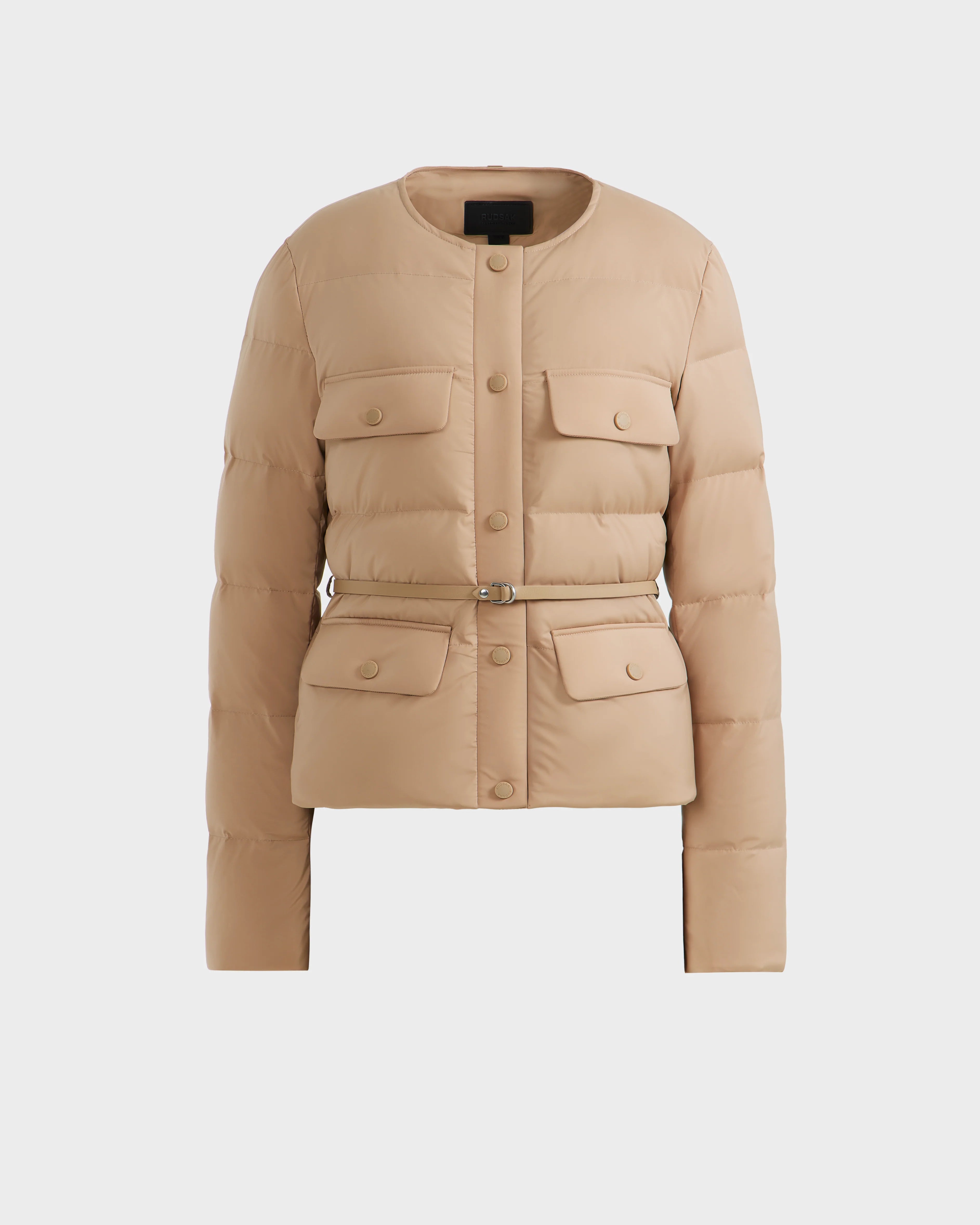 The FRANCESCA - 8125021 Almond by Rudsak is a beige quilted puffer jacket with a round collar, front buttons, RDS-certified down fill, chest and flap pockets, and a matching waist belt, shown on a plain white background.