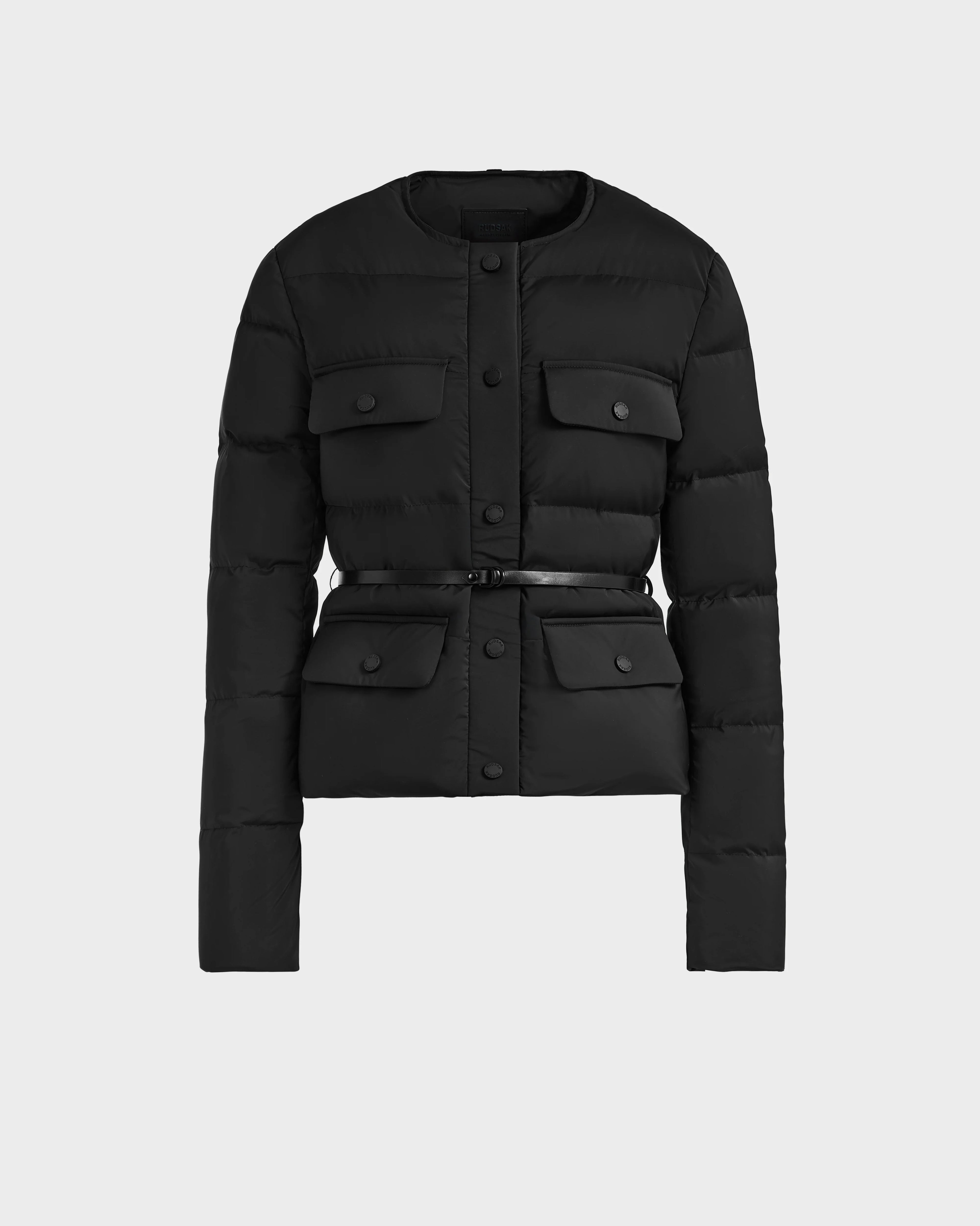 The FRANCESCA - 8125021 Black by Rudsak is a lightweight black puffer jacket featuring a sleek vegan leather belt for a modern, stylish look.