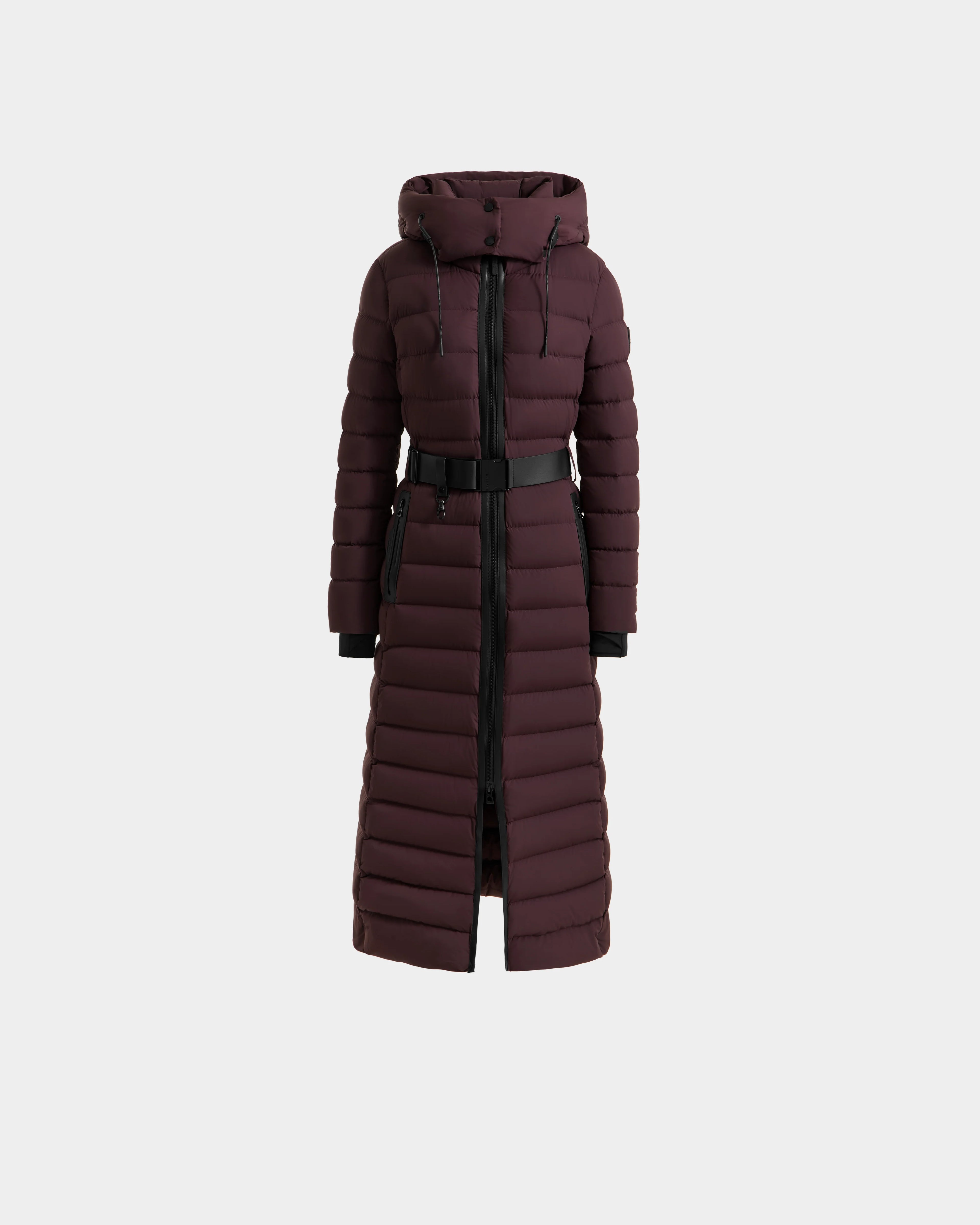 The Rudsak PELIN L - 8124815 Bordeaux is a women's long dark burgundy down puffer coat with a hood, black zipper, and adjustable waist belt. It features horizontal quilting, RDS-certified down, is water resistant, and extends to mid-calf. Displayed on white.