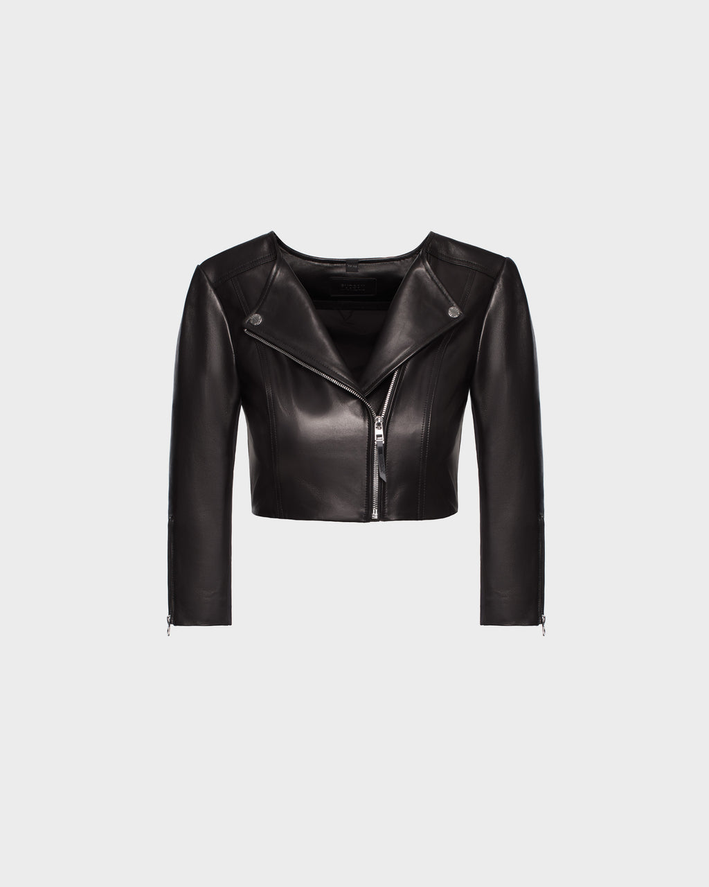 The WINNI - 8124053 Black by Rudsak is a fitted black cropped leather biker jacket with a front zipper, asymmetrical neckline, and long sleeves, shown on a plain light gray background.